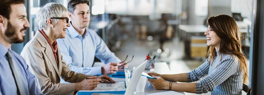 Business team talking to their candidate on a job interview in the office. Find Temporary Staffing Insurance.