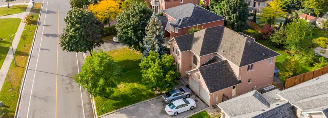 Aerial view of home and cars in driveway. Find New York Umbrella Insurance.