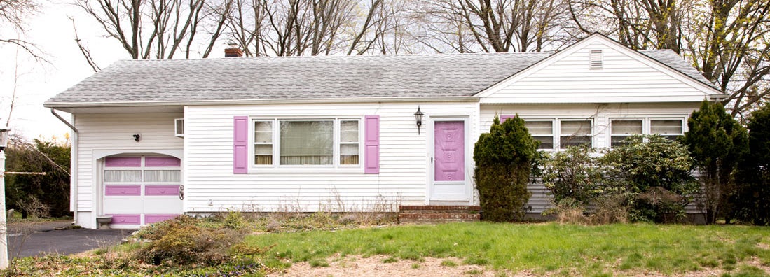 Run down house with dead lawn in foreground