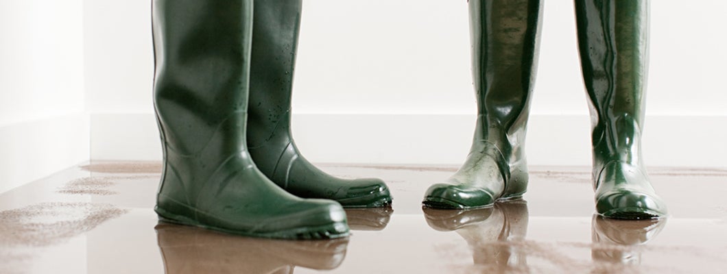 Couple in boots on flooded floor