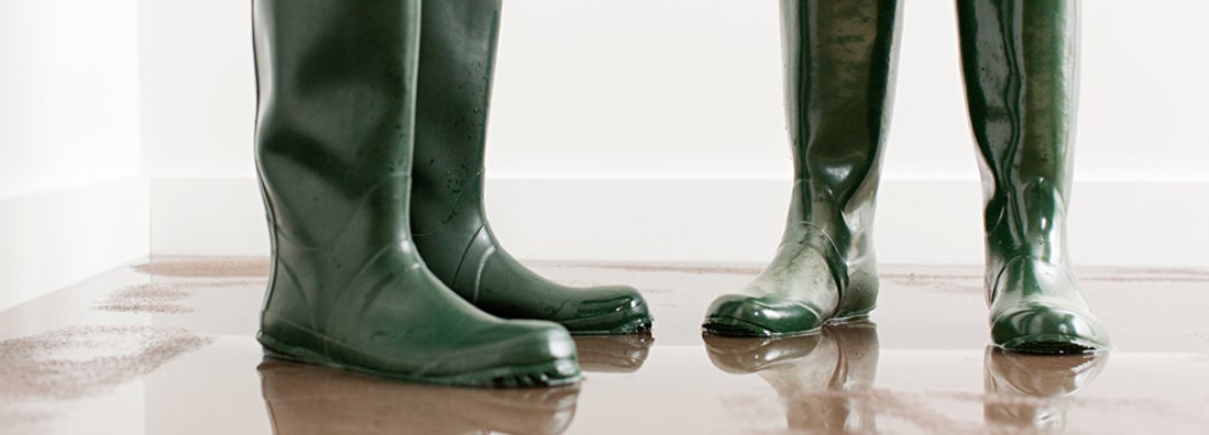 Couple in boots on flooded floor