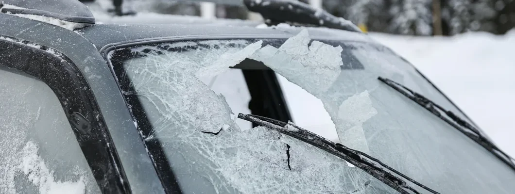 Broken windshield of a car after an accident in winter. What is Comprehensive Insurance? 