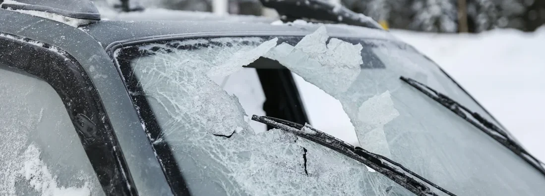 Broken windshield of a car after an accident in winter. What is Comprehensive Insurance?