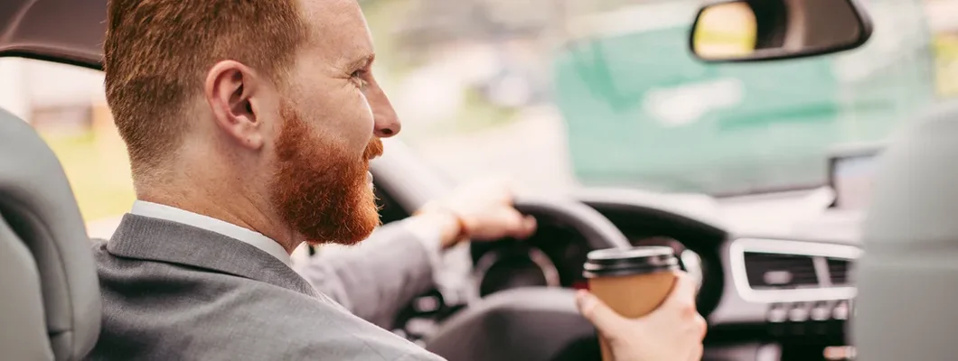Businessman in car. How to Find the Best Car Insurance Policy in Dunwoody, Georgia.