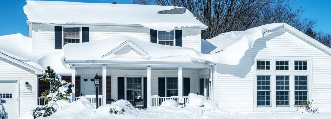 Deep Snow on Suburban Home Rooftop After Blizzard Snow Storm. Will Heavy Snow Damage my Roof? How Should I Fix It?