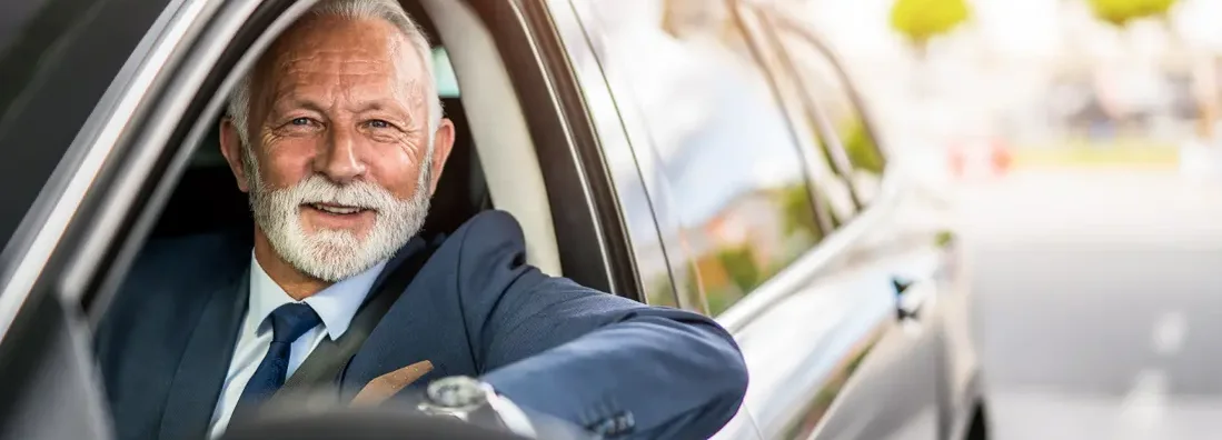 Senior businessman sitting in his car on daily commute. Find Troy, Michigan car insurance.