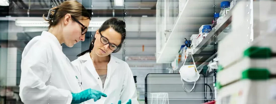 Two Scientists Reviewing Data In Lab Together. Find Life Sciences Insurance.