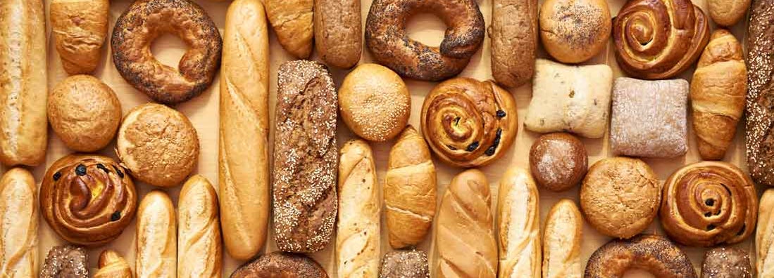 Bread baking rolls and croissants in baked goods store