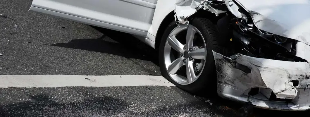 A white car just involved in a car crash at an intersection of a city street. What happens if you don't file a claim after a car accident?