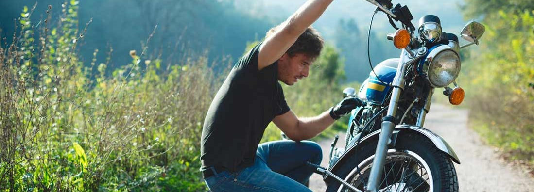 Young handsome male biker preparing to ride. Classic & Vintage Motorcycle Insurance.