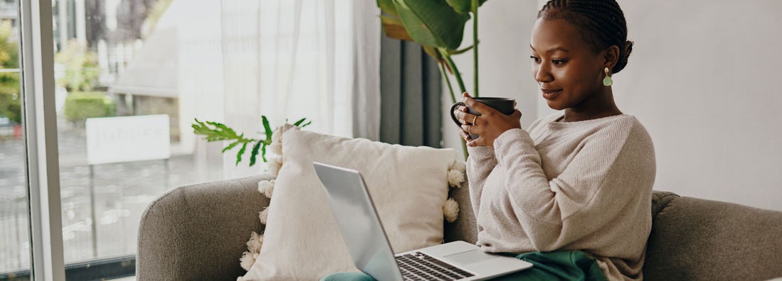 Woman having coffee and shopping online for insurance. Which is better, an independent agent or an online bot?