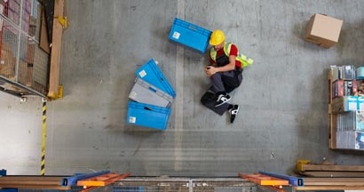 Man lying on the floor. Accident in warehouse