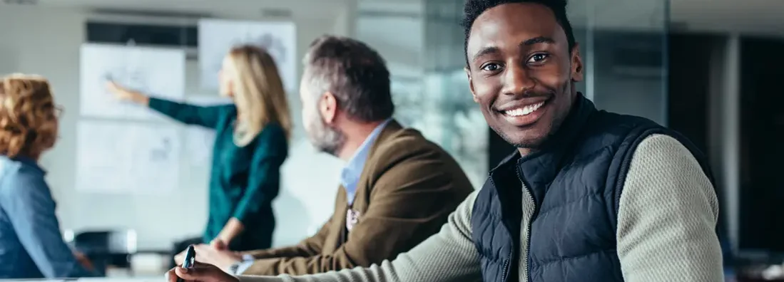 Young businessman sitting in conference room. Find Stamford, Connecticut business insurance.