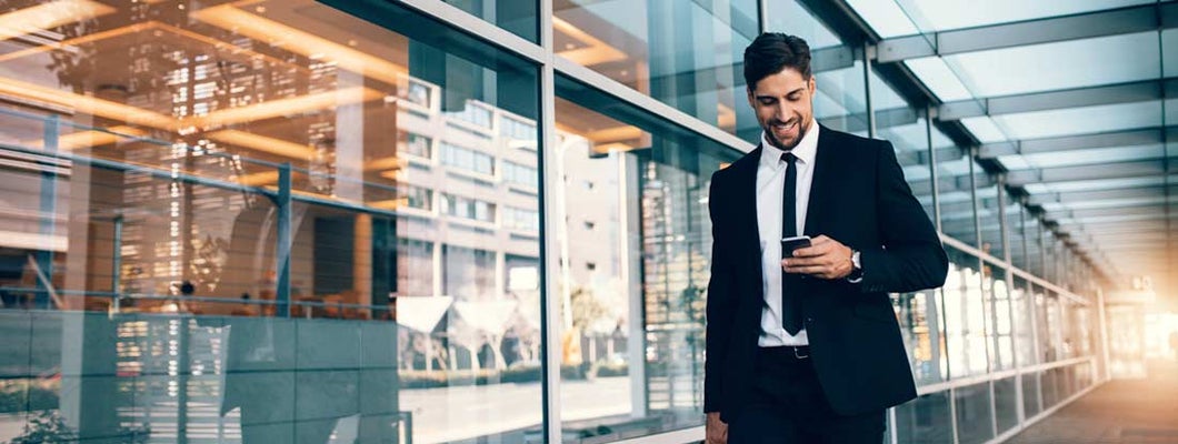 Business man looking at mobile phone