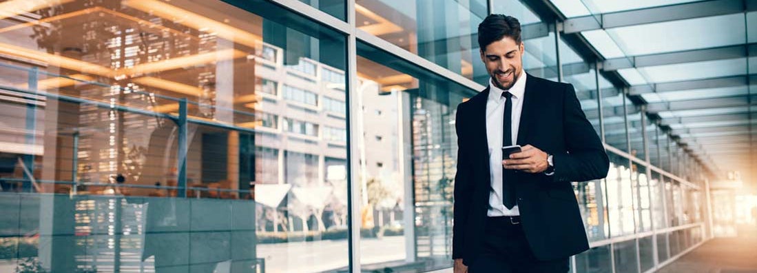 Business man looking at mobile phone