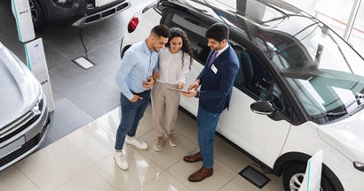 Customers having conversation with sales assistant, leasing a car. How to lease a car.