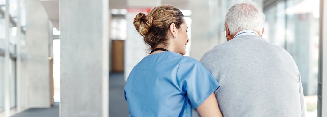 Nurse assisting her senior patient while walking. Find hybrid long term care insurance.