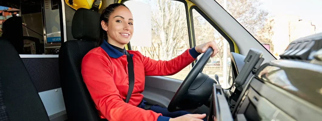 Female ambulance driver behind the wheel. Find South Dakota Commercial Vehicle Insurance.