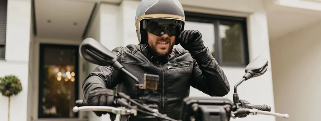 Man wearing safety helmet and preparing to ride his bike in the city. Find South Carolina Motorcycle Insurance.