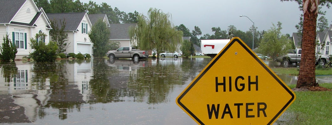 High Water Sign in Flooded Neighborhood