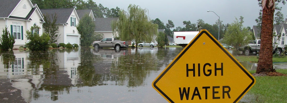 High Water Sign in Flooded Neighborhood