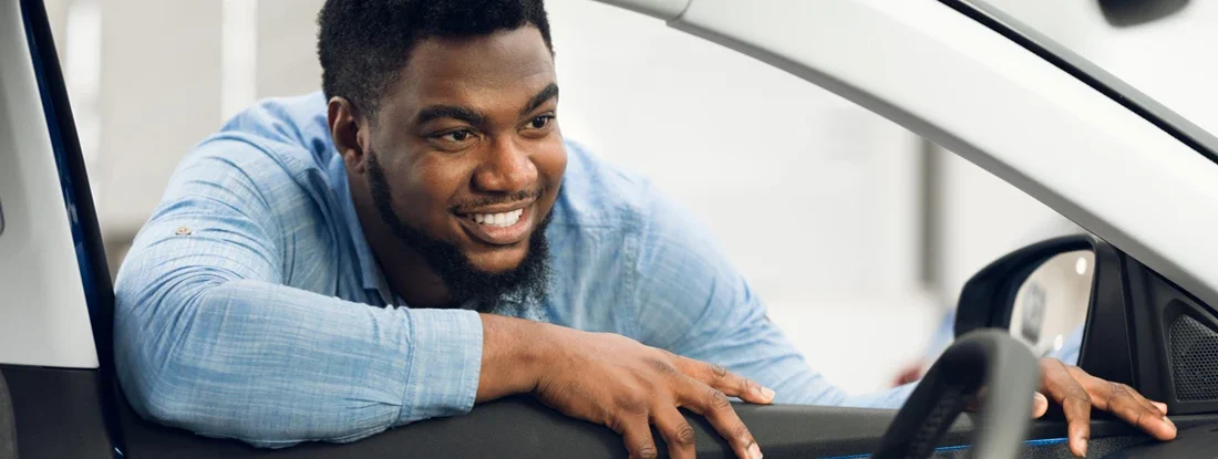 Man Looking At Car Interior In Dealership. New Car Checklist.