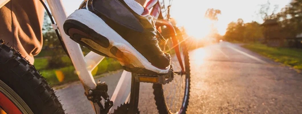 Close up of a foot on pedal of a cyclist outdoors. Find Bike Insurance.