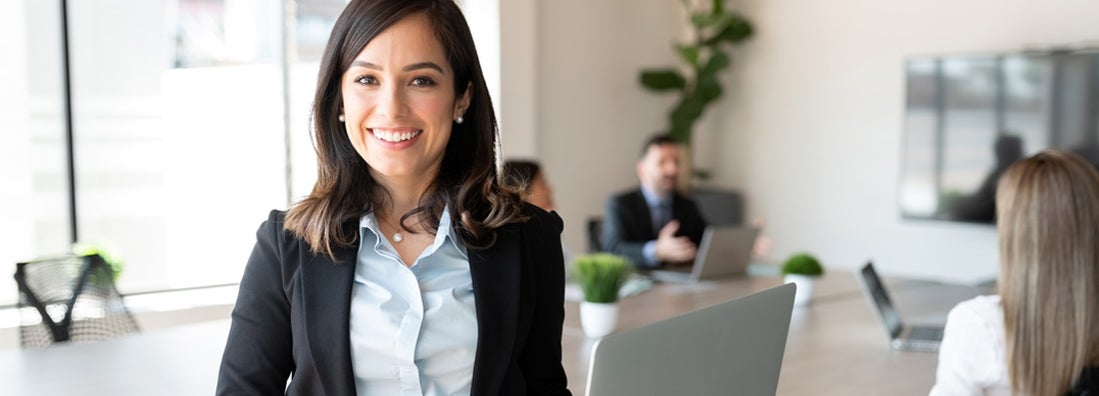 Smiling female independent insurance agent with laptop in a meeting room. Top 5 reasons an independent agent is way better than the other guys.