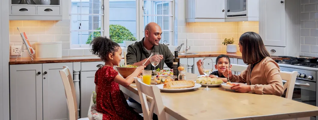 Shot of a young family enjoying a meal together. Jericho, New York Homeowners Insurance.