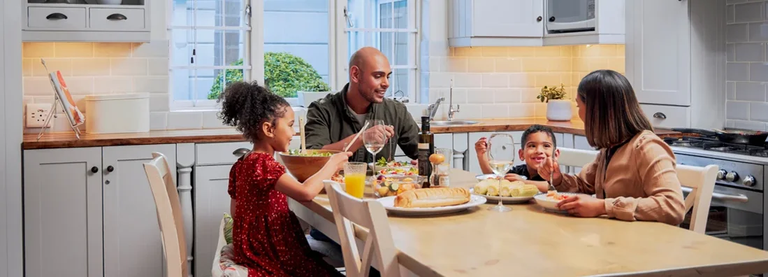 Shot of a young family enjoying a meal together. Jericho, New York Homeowners Insurance.