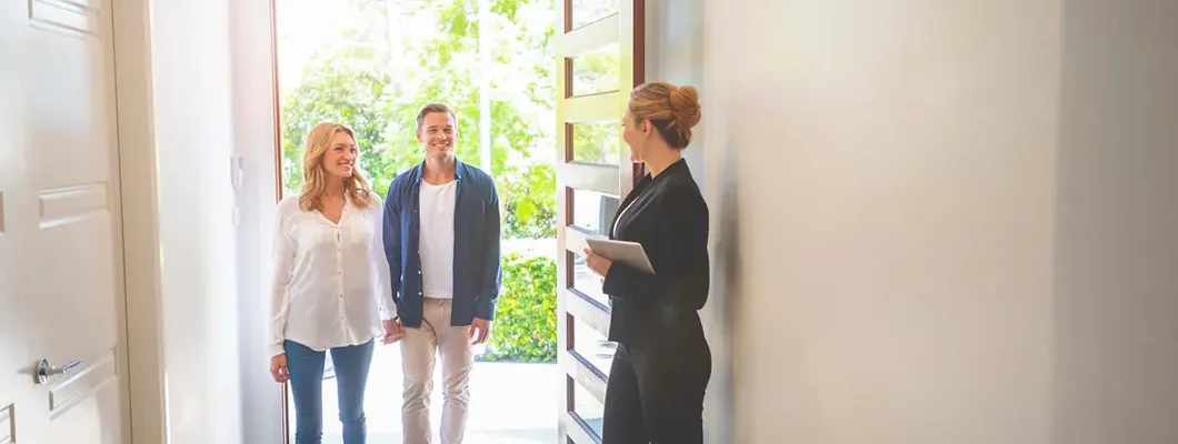 Landlord showing a young couple a new apartment. Find South Dakota landlord insurance.