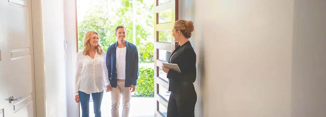 Landlord showing a young couple a new apartment. Find South Dakota landlord insurance.