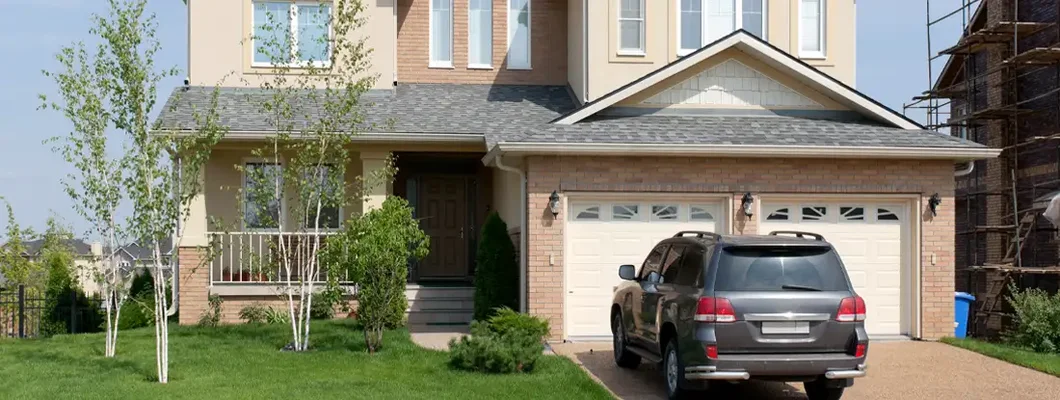 Brand new suburban house in sunny summer afternoon. Find South Dakota umbrella insurance.