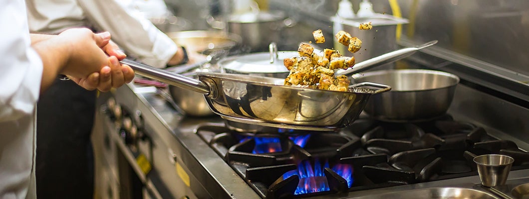 Chef preparing cuisine in restaurant kitchen