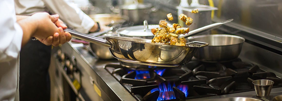 Chef preparing cuisine in restaurant kitchen