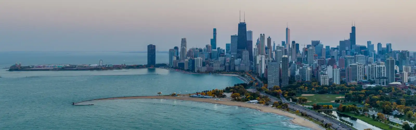 Aerial view of Chicago downtown skyline with park and the beach. Find Illinois insurance.