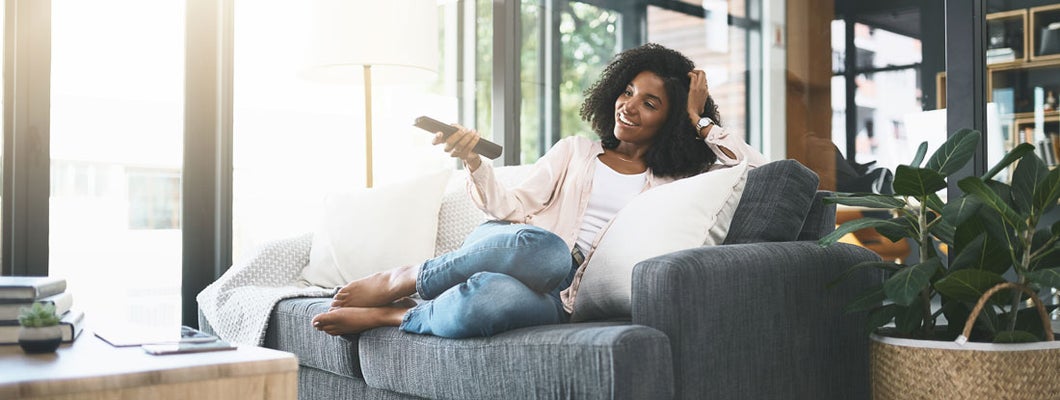 Young woman relaxing in her apartment. Find West Virginia Renters Insurance.