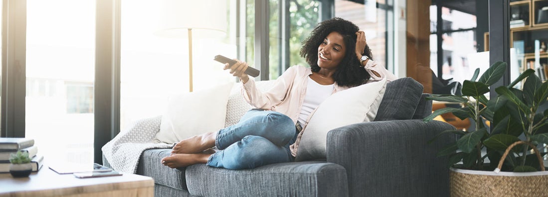 Young woman relaxing in her apartment. Find West Virginia Renters Insurance.