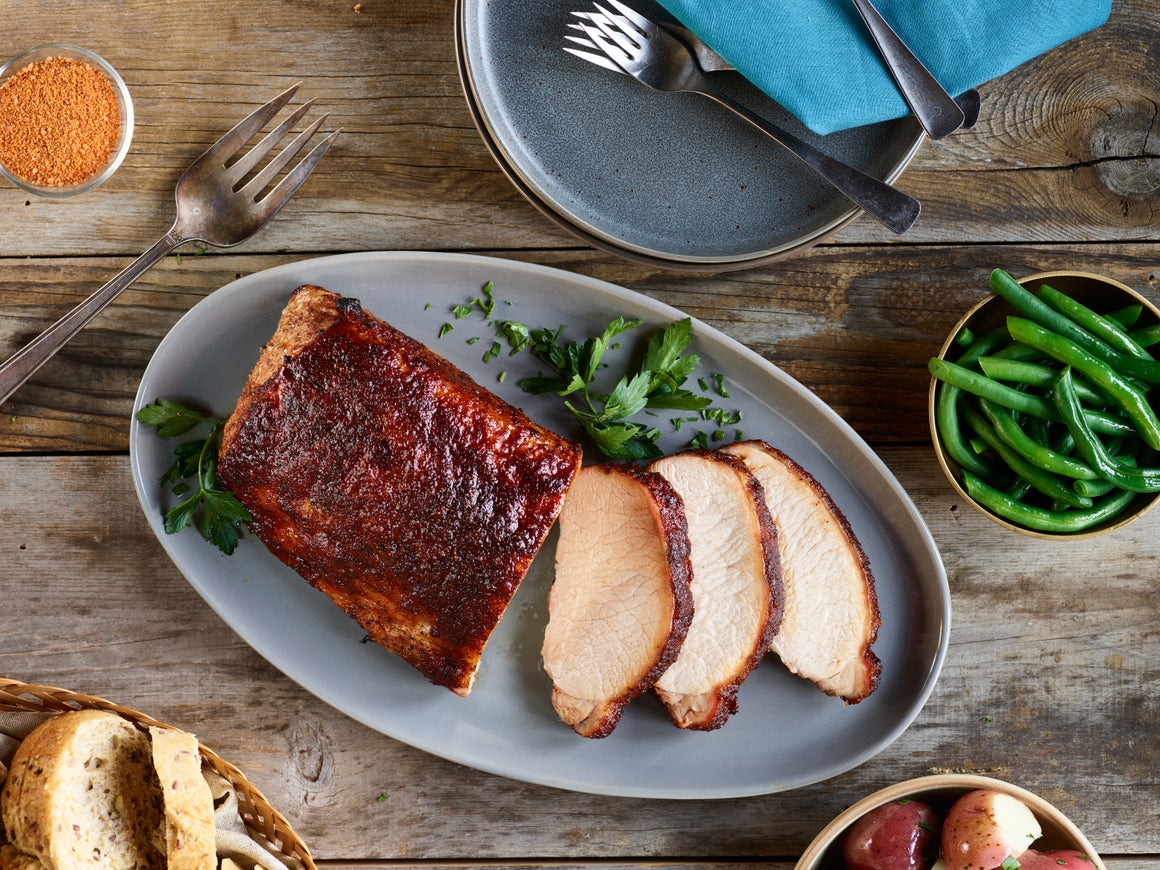 Oven-roasted pork with seasonal vegetables makes for an effortless and flavorful centerpiece.
