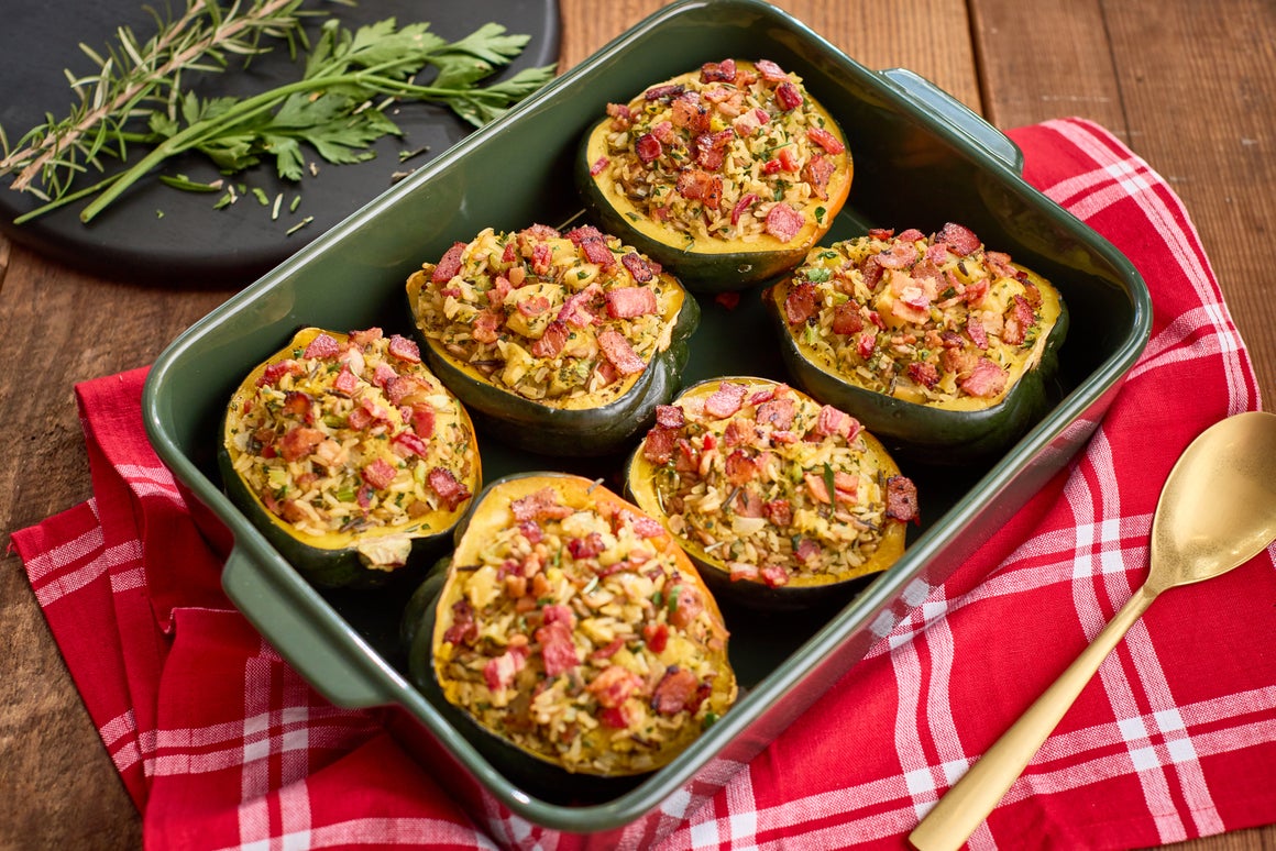 The sweet, nutty flesh of the acorn squash pairs perfectly with a savory filling of rice, aromatic herbs, and the irresistible crunch of bacon.