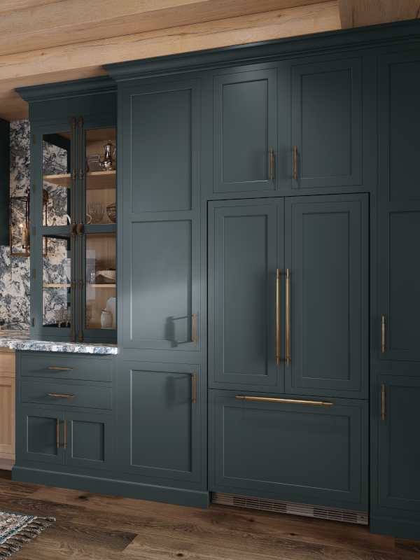 In this kitchen, the integrated refrigerator blends in with the green cabinets and pantry doors next to it.