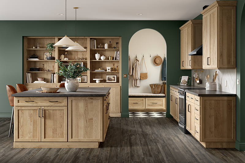 A kitchen with wood stained cabinets and dark gray countertops.