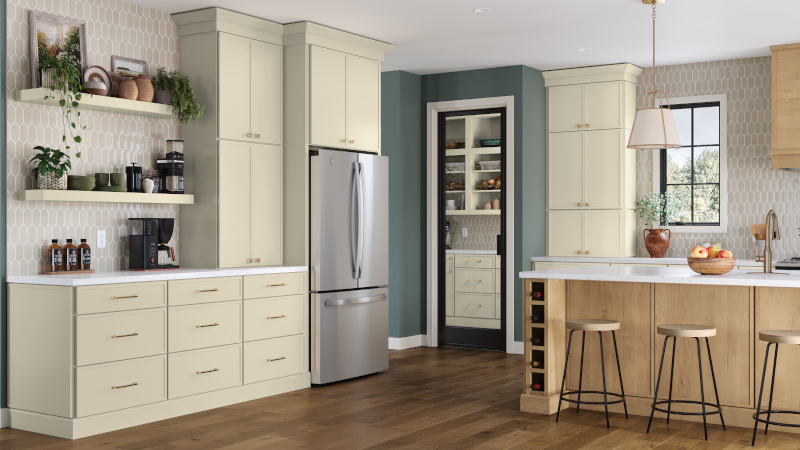 A kitchen with off-white kitchen cabinets featuring a dedicated beverage station as well as a natural wood kitchen island with dining stools.