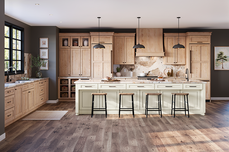 A kitchen with a mix of off-white and wood-toned kitchen cabinets and distressed wood flooring.
