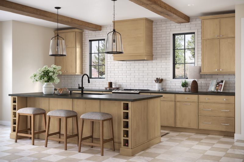 A kitchen that has a multipurpose island with dining chairs and room for food prep.