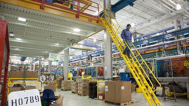 Man walking down alternating tread stairs