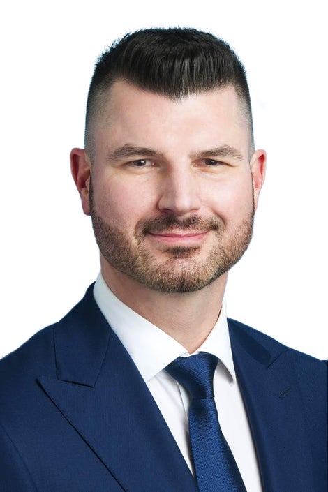 Man with short hair and light beard looks directly at the camera.