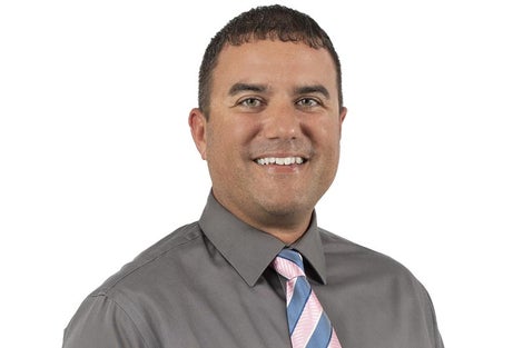 Man in gray dress shirt and tie.