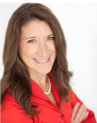 Brown-haired woman with red blouse and pearl necklace.