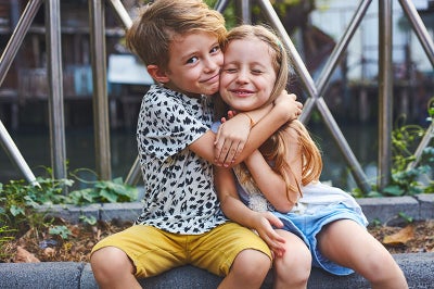 Young boy and girl hug.